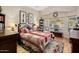 Comfortable bedroom with a plush bed, elegant decor, and plenty of natural light streaming through large windows at 25821 N 41St Dr, Phoenix, AZ 85083