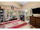 Charming bedroom featuring large windows, a decorative desk, and ensuite bathroom access at 25821 N 41St Dr, Phoenix, AZ 85083