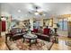 Spacious living area with hardwood floors, a large mirror, comfortable seating, and seamless kitchen access at 25821 N 41St Dr, Phoenix, AZ 85083