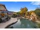 Inviting backyard pool area featuring a waterfall feature, lush landscaping, and lounge seating at 25821 N 41St Dr, Phoenix, AZ 85083
