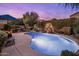 Sparkling pool with comfortable lounge chairs, a red umbrella and mature landscaping at 25821 N 41St Dr, Phoenix, AZ 85083