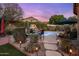 Backyard pool area with stone paths and lush landscaping, perfect for relaxation and entertainment at 25821 N 41St Dr, Phoenix, AZ 85083