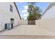 Wide shot of backyard and enclosed parking spot, with gate, between the houses at 2619 S Los Altos --, Mesa, AZ 85202