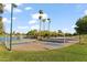 A basketball court next to a lake with walking paths, landscaping, and palm trees at 2619 S Los Altos --, Mesa, AZ 85202