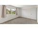 Cozy bedroom with neutral carpet, a large window, and closet at 2619 S Los Altos --, Mesa, AZ 85202
