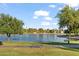 Scenic lake with ducks, green grass, trees, and a park bench in a peaceful community setting at 2619 S Los Altos --, Mesa, AZ 85202