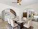 Elegant dining room with modern table and chairs, showcasing arched doorways and stylish decor at 2619 S Los Altos --, Mesa, AZ 85202