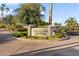 Community entrance sign for Los Altos Center set amongst lush landscaping with palm trees at 2619 S Los Altos --, Mesa, AZ 85202