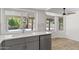 Modern kitchen featuring stainless steel appliances, gray cabinets, and a view of the pool through a window at 2619 S Los Altos --, Mesa, AZ 85202