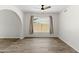 Open concept living room featuring wood-look flooring, white walls, a ceiling fan, and a large window at 2619 S Los Altos --, Mesa, AZ 85202