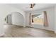 Bright living room featuring wood-look flooring, white walls, a ceiling fan, and a large picture window at 2619 S Los Altos --, Mesa, AZ 85202