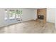 Living area featuring light wood flooring and a red brick fireplace and French doors at 2619 S Los Altos --, Mesa, AZ 85202