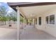 Long covered patio with a tiled floor and views of the landscaped backyard at 2619 S Los Altos --, Mesa, AZ 85202