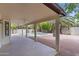 Covered patio with tile flooring overlooking the pool and lush landscaping in the backyard at 2619 S Los Altos --, Mesa, AZ 85202