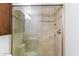 Bathroom with a glass-enclosed shower, neutral tile, and dark wood cabinets at 2619 S Los Altos --, Mesa, AZ 85202