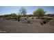 Another view of the backyard showing desert landscaping and a golf course at 27083 W Marco Polo Rd, Buckeye, AZ 85396