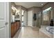 Bright bathroom with dual sinks, large walk-in shower, and separate tub at 27083 W Marco Polo Rd, Buckeye, AZ 85396