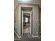 Open doorway revealing a bathroom with a glass-enclosed shower and a luxurious soaking tub at 27083 W Marco Polo Rd, Buckeye, AZ 85396