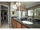 Stylish bathroom with double sinks, granite countertops, and convenient access to the walk-in closet at 27083 W Marco Polo Rd, Buckeye, AZ 85396