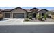 Beautiful single story home with a stone facade and mature landscaping at 27083 W Marco Polo Rd, Buckeye, AZ 85396