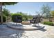 Inviting outdoor firepit with seating on a paved patio, perfect for relaxing and entertaining at 27083 W Marco Polo Rd, Buckeye, AZ 85396
