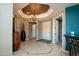 Spacious foyer with decorative tile flooring, designer accents, and chandelier lighting at 27083 W Marco Polo Rd, Buckeye, AZ 85396