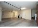 Clean and spacious garage interior with room for multiple vehicles and storage, including garage door openers at 27083 W Marco Polo Rd, Buckeye, AZ 85396