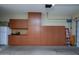 Garage with overhead storage cabinets, shelving, and epoxy flooring at 27083 W Marco Polo Rd, Buckeye, AZ 85396