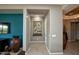 Inviting hallway with neutral tones and decorative accents, leading into a well-lit home interior at 27083 W Marco Polo Rd, Buckeye, AZ 85396