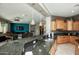 Stylish kitchen with granite countertops, modern appliances, and an open view to the living room at 27083 W Marco Polo Rd, Buckeye, AZ 85396