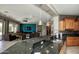 Stylish kitchen with granite countertops, modern appliances, and an open view to the living room at 27083 W Marco Polo Rd, Buckeye, AZ 85396