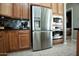 Modern kitchen featuring stainless steel refrigerator and built-in microwave and oven at 27083 W Marco Polo Rd, Buckeye, AZ 85396
