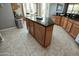 The spacious kitchen features an island with granite countertops, cabinets, and tile floors at 27083 W Marco Polo Rd, Buckeye, AZ 85396