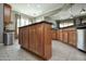 The kitchen features an island with granite countertops, lots of cabinets, recessed lights, and tile floors at 27083 W Marco Polo Rd, Buckeye, AZ 85396