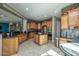 Expansive kitchen featuring wood cabinets, granite countertops, stainless steel appliances, and tile flooring at 27083 W Marco Polo Rd, Buckeye, AZ 85396