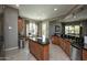 Open kitchen and breakfast nook featuring an island, granite countertops, and lots of cabinets at 27083 W Marco Polo Rd, Buckeye, AZ 85396