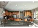 Spacious kitchen features wood cabinets, granite countertops, stainless steel appliances, and a breakfast bar at 27083 W Marco Polo Rd, Buckeye, AZ 85396