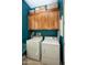 A laundry room featuring side-by-side washer and dryer, cabinets, and blue walls at 27083 W Marco Polo Rd, Buckeye, AZ 85396