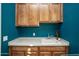 Laundry room featuring a utility sink with cabinets, and blue walls at 27083 W Marco Polo Rd, Buckeye, AZ 85396