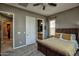 Cozy main bedroom with a wicker bed frame and ensuite bathroom access at 27083 W Marco Polo Rd, Buckeye, AZ 85396