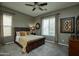 Comfortable main bedroom featuring a ceiling fan and sunlit window at 27083 W Marco Polo Rd, Buckeye, AZ 85396