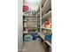 A well-organized pantry with shelves stocked with food and household supplies at 27083 W Marco Polo Rd, Buckeye, AZ 85396