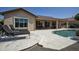 An expansive covered patio complements the backyard pool and outdoor lounge area at 27083 W Marco Polo Rd, Buckeye, AZ 85396