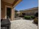 Outdoor patio with lush landscaping and stone pavers at 27083 W Marco Polo Rd, Buckeye, AZ 85396