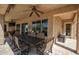 Covered patio with ceiling fans and an outdoor dining area at 27083 W Marco Polo Rd, Buckeye, AZ 85396