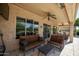Outdoor patio with plush seating and views of the backyard at 27083 W Marco Polo Rd, Buckeye, AZ 85396