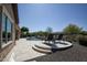 Inviting backyard pool and patio area features beautiful landscaping and comfortable lounge seating at 27083 W Marco Polo Rd, Buckeye, AZ 85396