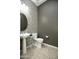 Stylish powder room featuring a pedestal sink and mosaic tile accent wall at 27083 W Marco Polo Rd, Buckeye, AZ 85396