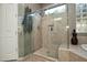 Modern shower with a glass door, tiled walls, and a built-in niche at 27083 W Marco Polo Rd, Buckeye, AZ 85396