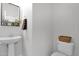 Modern half bath features a pedestal sink and neutral wall colors at 2950 E Dublin St, Gilbert, AZ 85295